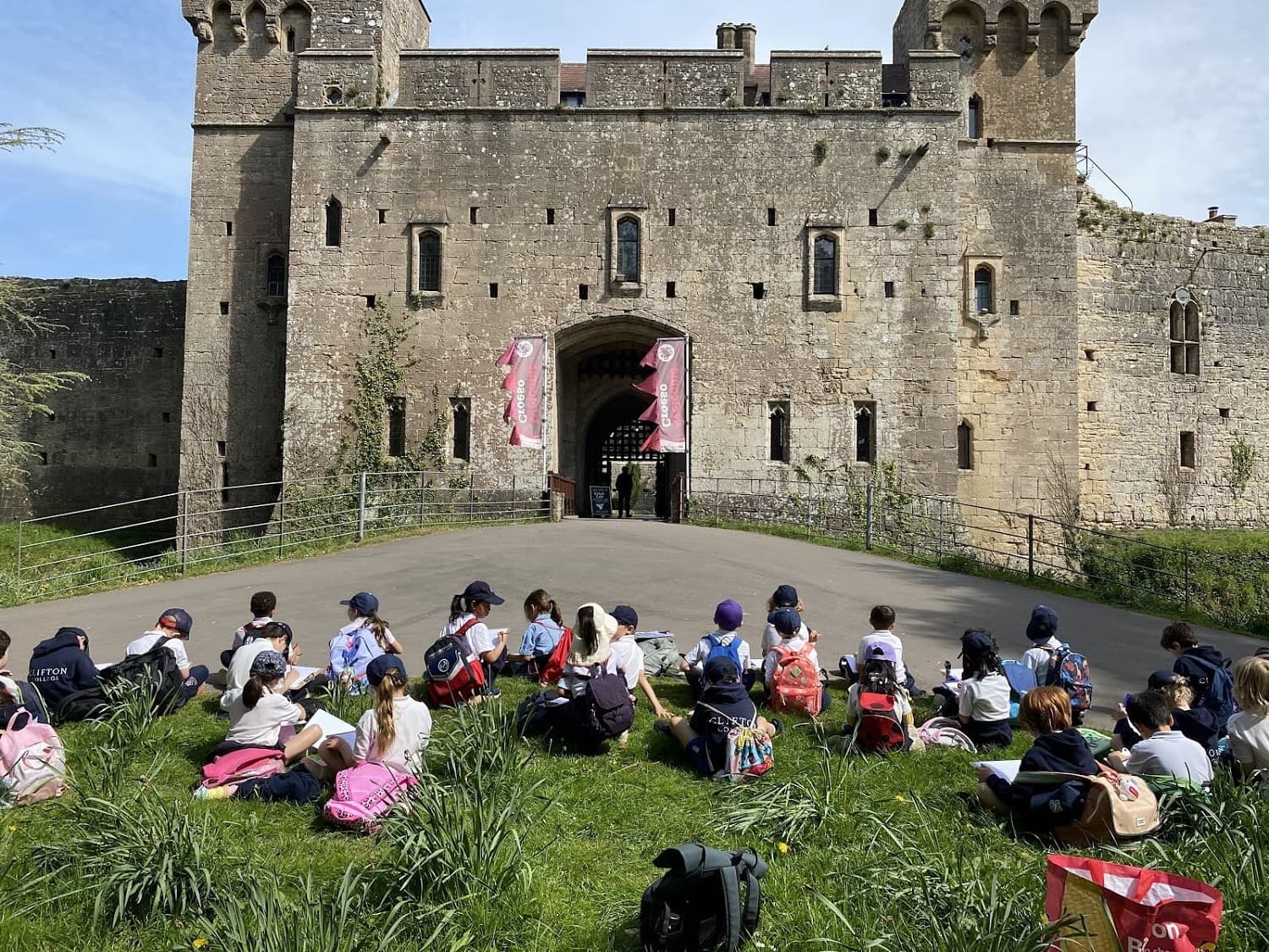 Children sitting in front of a castle