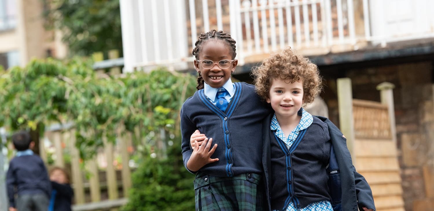 Two girls smiling in the playground