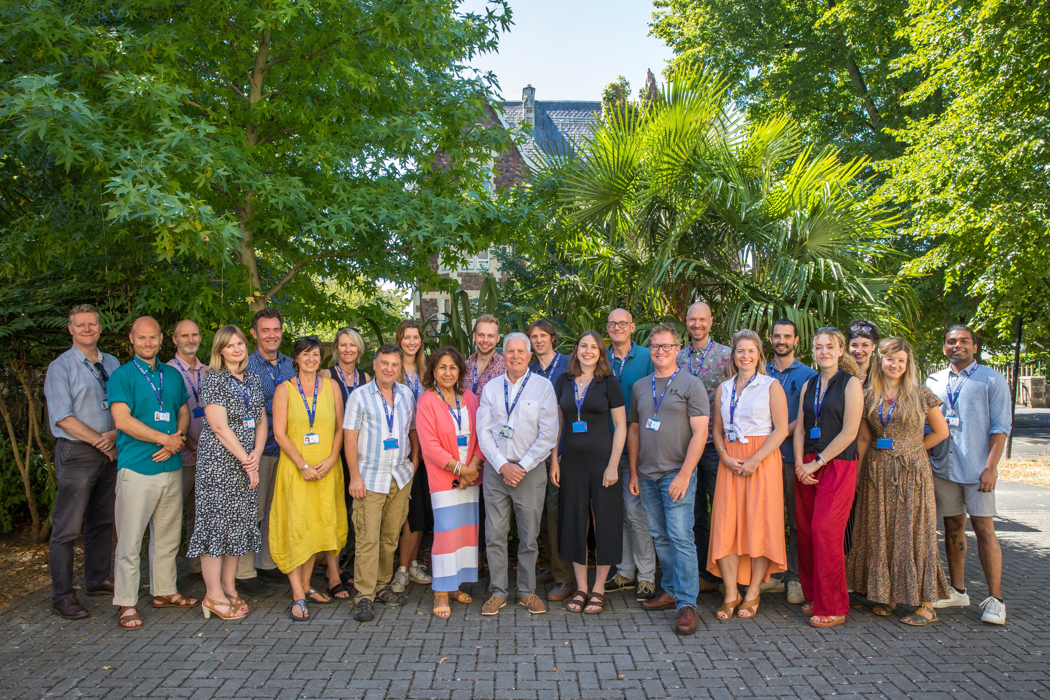 A group of ELC staff members posing for a photograph outside